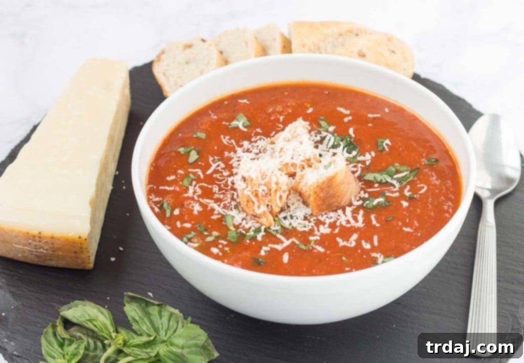 Experience the rich flavors of Slow Cooker Roasted Red Pepper and Tomato Soup, a wholesome and easy-to-make dish for the entire family. Close-up of creamy Slow Cooker Roasted Red Pepper and Tomato Soup