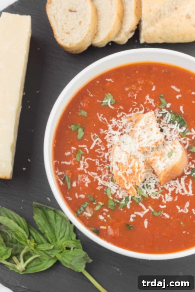 Enjoy a nutritious and flavorful Slow Cooker Roasted Red Pepper and Tomato Soup, perfect for a cozy meal. Delicious Slow Cooker Roasted Red Pepper and Tomato Soup in a bowl with fresh basil