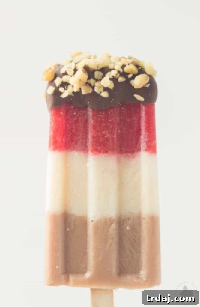 Layers of fresh strawberries, Sir BananamilkTM, and Sir Chocolate BananamilkTM make these Banana Split Popsicles irresistible to both adults and children alike. | Strawberry Blondie Kitchen