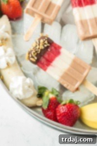 Layers of fresh strawberries, Sir BananamilkTM, and Sir Chocolate BananamilkTM make these Banana Split Popsicles irresistible to both adults and children alike. | Strawberry Blondie Kitchen