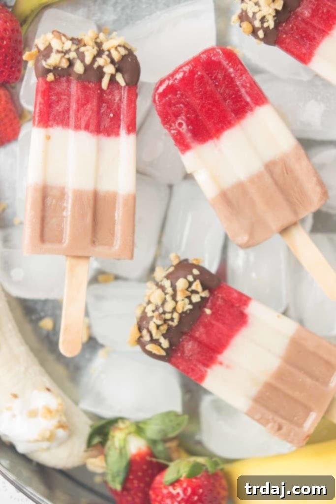 Layers of fresh strawberries, Sir BananamilkTM, and Sir Chocolate BananamilkTM make these Banana Split Popsicles irresistible to both adults and children alike. | Strawberry Blondie Kitchen