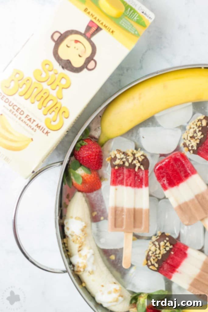 Layers of fresh strawberries, Sir BananamilkTM, and Sir Chocolate BananamilkTM make these Banana Split Popsicles irresistible to both adults and children alike. | Strawberry Blondie Kitchen
