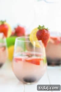 Berry Basil Lemonade in a glass with fresh ingredients