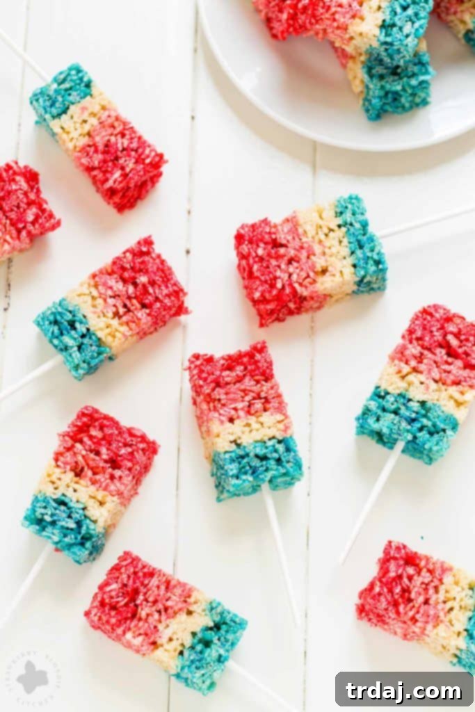 Freedom Fluffs 10 Patriotic Crispy Treats arranged on a platter with a festive American flag background, ready for a party.