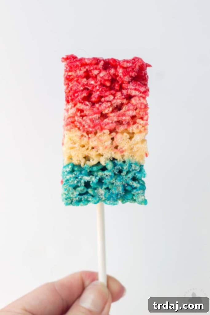 Freedom Fluffs 3 Close-up of vibrant red, white, and blue crispy treats, showcasing the distinct layers of flavor.