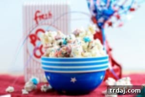 Freedom Fluffs 4 Festive Firecracker Popcorn Mix with sweet and salty flavors, perfect for parties.