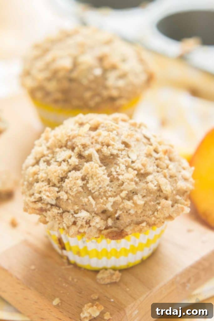 Delicious Peach Oatmeal Crumb Muffins with a golden, crispy topping, perfect for a cozy morning breakfast or a delightful afternoon treat. | Strawberry Blondie Kitchen