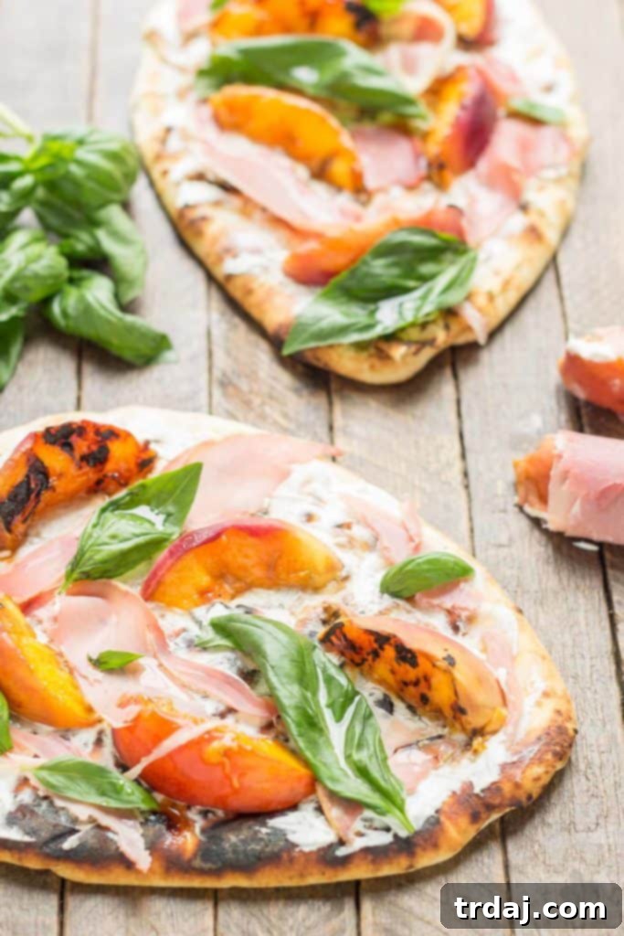 Close-up of a delicious Grilled Peach, Prosciutto and Goat Cheese Pizza on garlic naan, showcasing vibrant peaches and melted goat cheese | Strawberry Blondie Kitchen