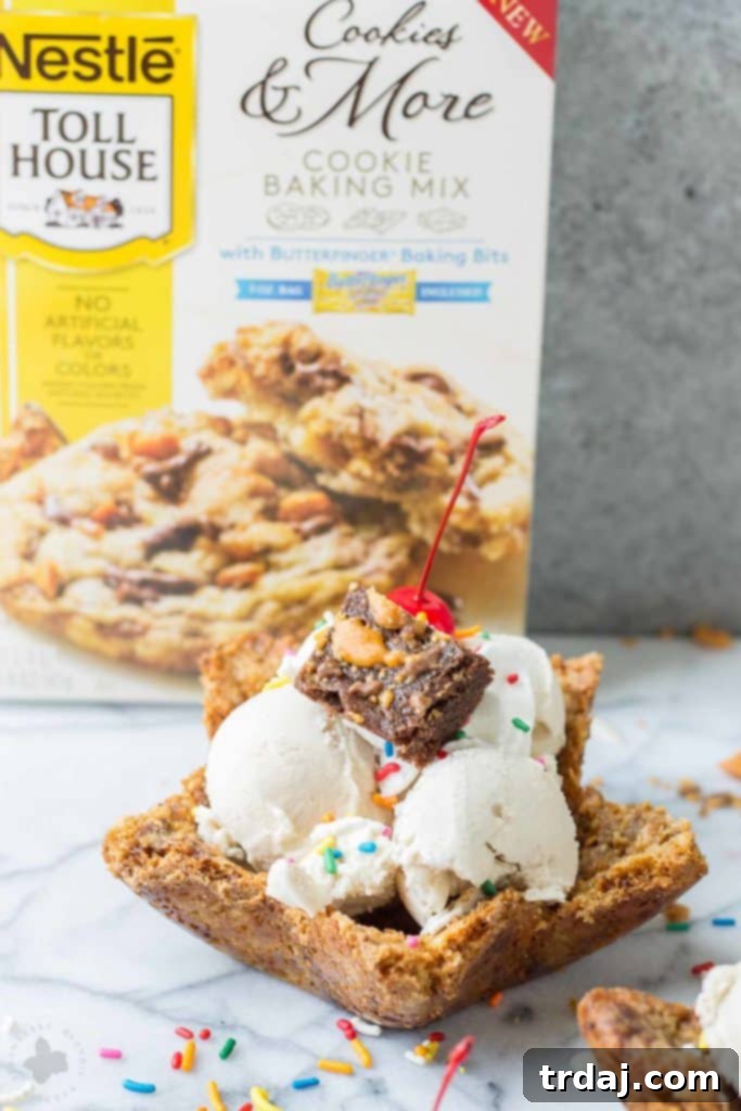 Golden brown chocolate chip cookie bowl brimming with colorful ice cream and sprinkles, ready to be eaten