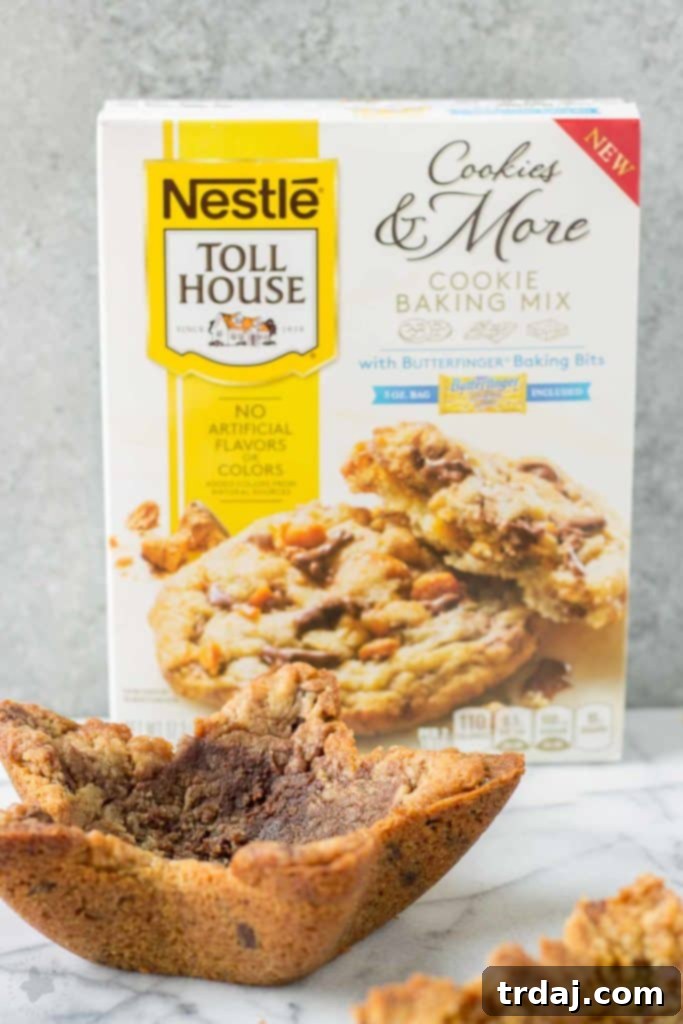 A freshly baked edible cookie bowl being carefully removed from its mold
