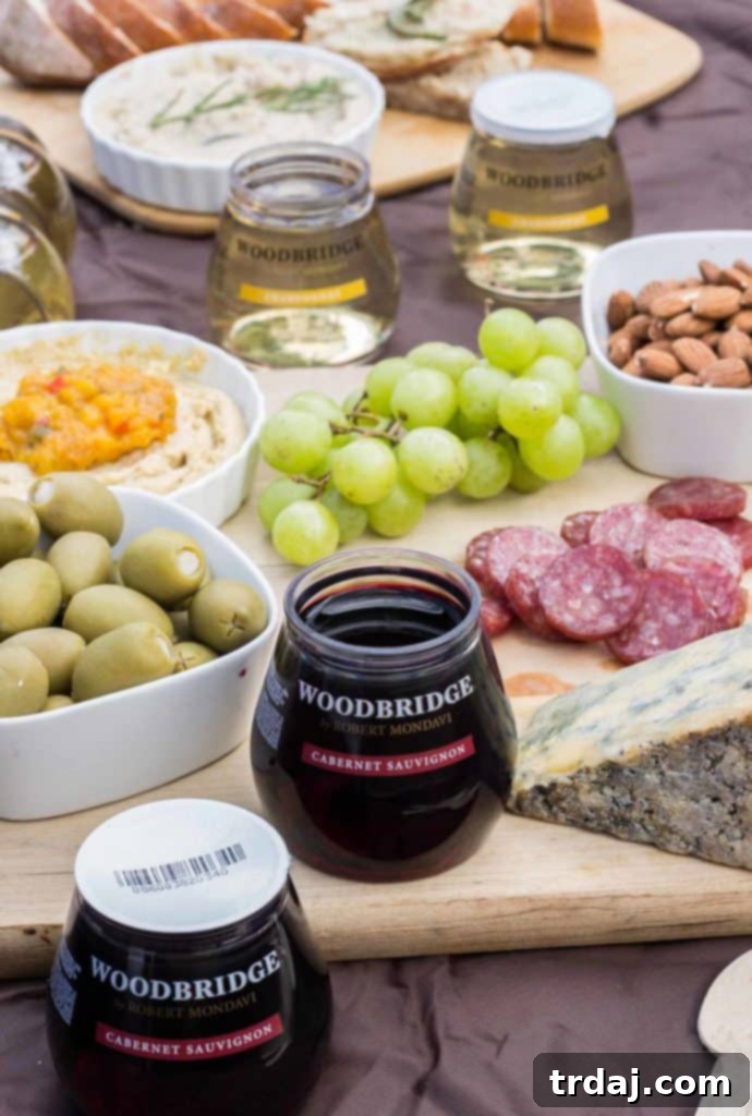 A romantic picnic featuring Mini Chocolate Mason Jars with Cherry Jam and Woodbridge by Robert Mondavi wine.