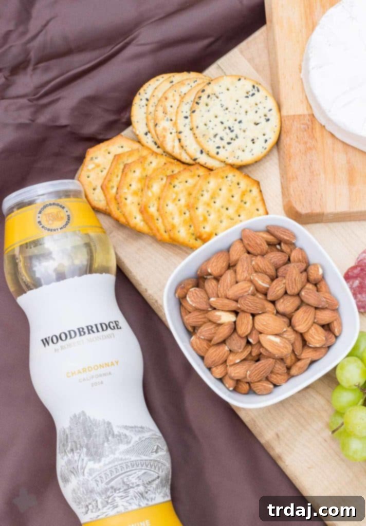 Preparing a gourmet charcuterie board for a romantic picnic, featuring cheeses, meats, and fresh fruits.