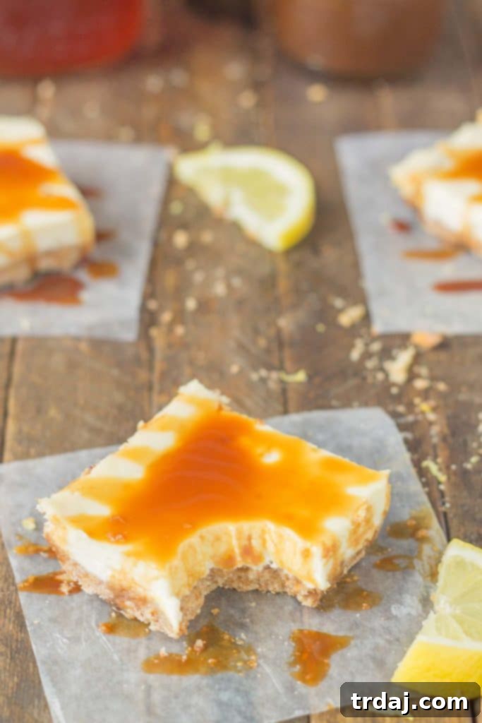 Tray of freshly baked Arnold Palmer Cheesecake Bars, showing the creamy lemon filling and a generous drizzle of sweet tea caramel.