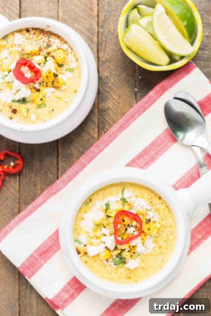 Overhead shot of two bowls of Mexican Street Corn Chowder, beautifully garnished and ready to be served, emphasizing the creamy texture.