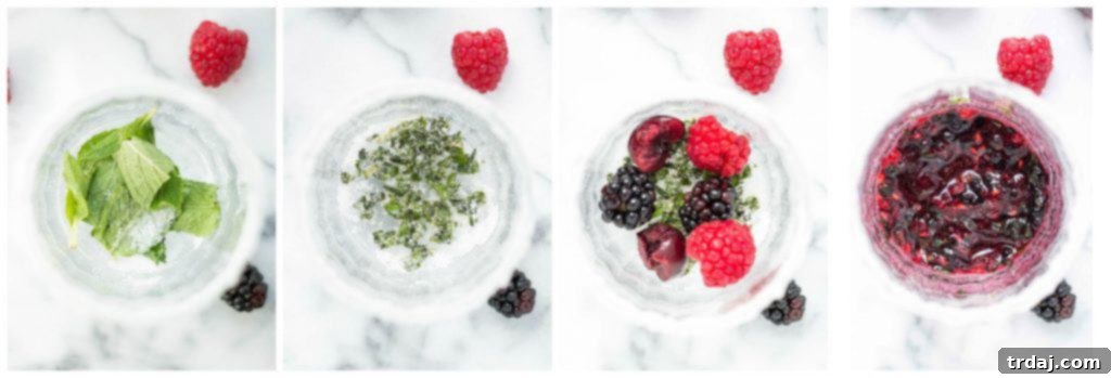 A close-up of a perfectly garnished Triple Berry Mojitini with fresh berries and a lime wedge, ready to be enjoyed at a summer gathering.