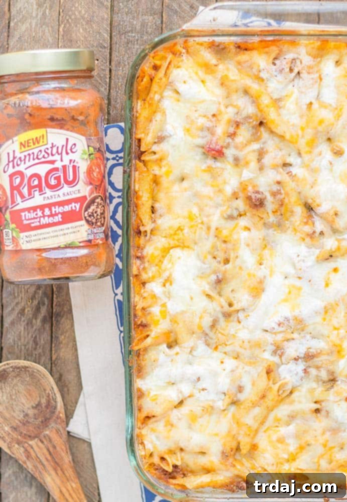 A serving of baked mostaccioli, showcasing the rich meat sauce and abundant, melted cheese layers.