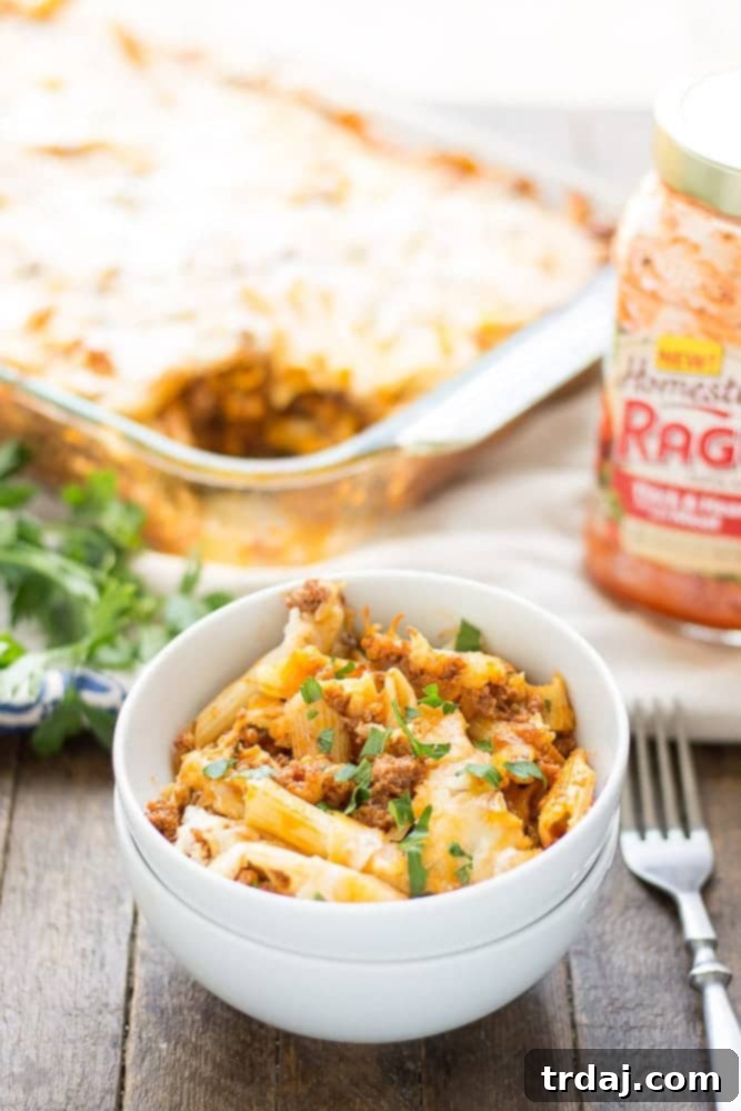 Delicious Baked Mostaccioli dish with steam rising, indicating it's fresh from the oven, ready to be served.