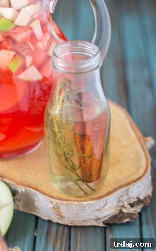 Close-up of fresh fruit slices – apples, pears, oranges, and lemons – used in the Cranberry Apple Rosemary Sangria, showcasing vibrant colors and textures.