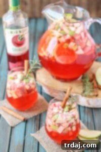 A delicious blend of cranberries, apples, cinnamon, rosemary and seasonal fruits make this Cranberry Apple Rosemary Sangria the go to cocktail of Autumn. | Strawberry Blondie Kitchen