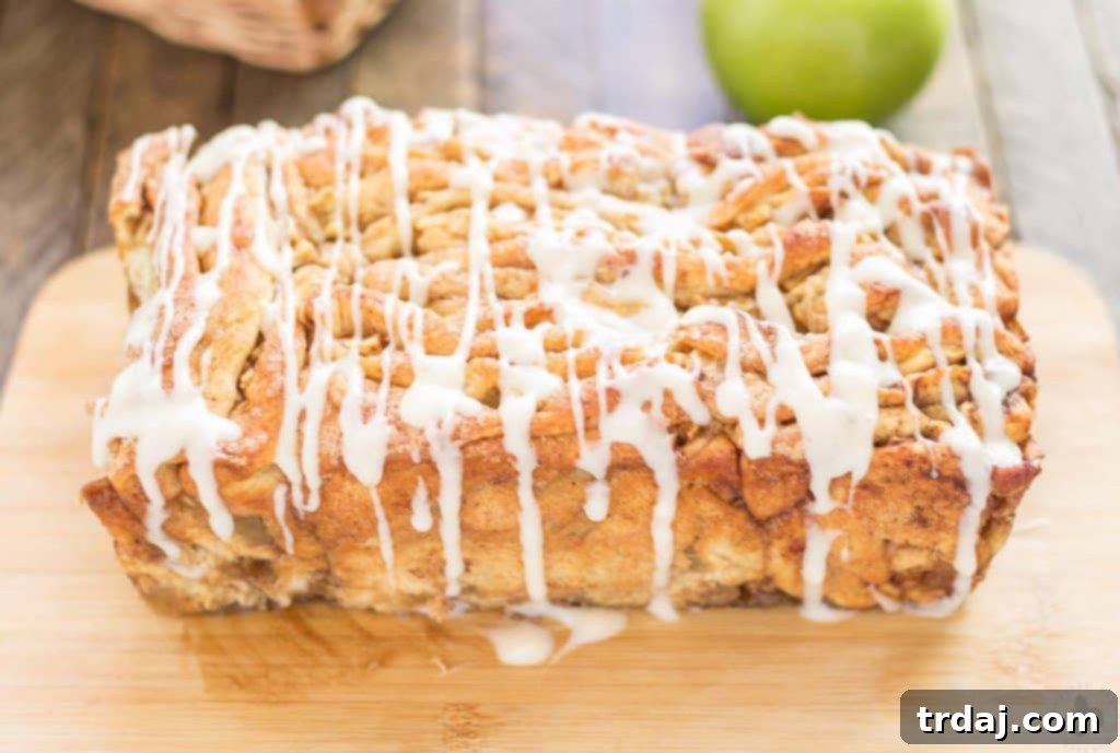 Apple Pie Pull Apart Bread is filled with chopped apples, cinnamon, brown sugar and drizzled with a cream cheese glaze. Sure to give Apple Pie a run for its money! | Strawberry Blondie Kitchen