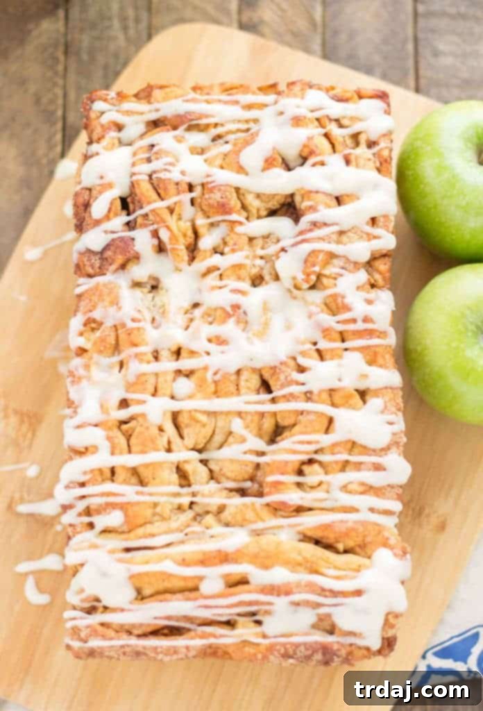 Apple Pie Pull Apart Bread is filled with chopped apples, cinnamon, brown sugar and drizzled with a cream cheese glaze. Sure to give Apple Pie a run for its money! | Strawberry Blondie Kitchen