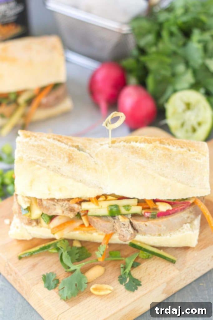 Close-up of a Banh Mi sandwich with marinated pork and fresh vegetables