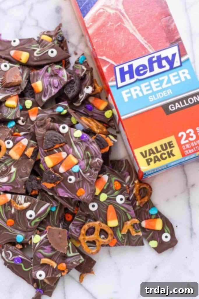 Monster Mash Bark 2 Delicious Halloween Candy Bark made with colorful chocolate and assorted candies, a perfect no-bake treat for families.