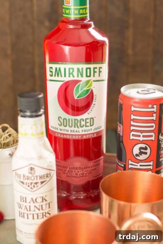 A beautifully arranged Cranberry Apple Moscow Mule on a wooden tray with a backdrop of autumn decor, inviting you to try this seasonal fall drink.