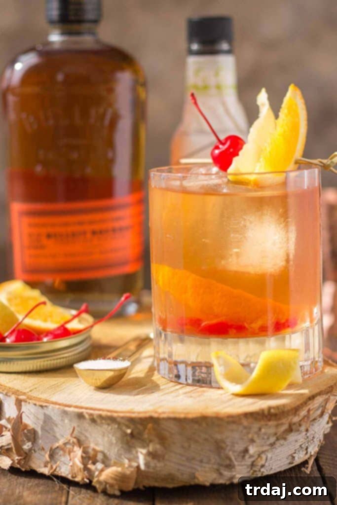 A Black Walnut Old Fashioned cocktail, elegantly presented with a focus on its inviting amber glow.