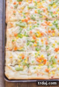 Turkey Pot Pie Pizza Bake 8 The ultimate Leftover Turkey Pot Pie Slab Pizza, a comforting and flavorful way to use Thanksgiving turkey. | Strawberry Blondie Kitchen