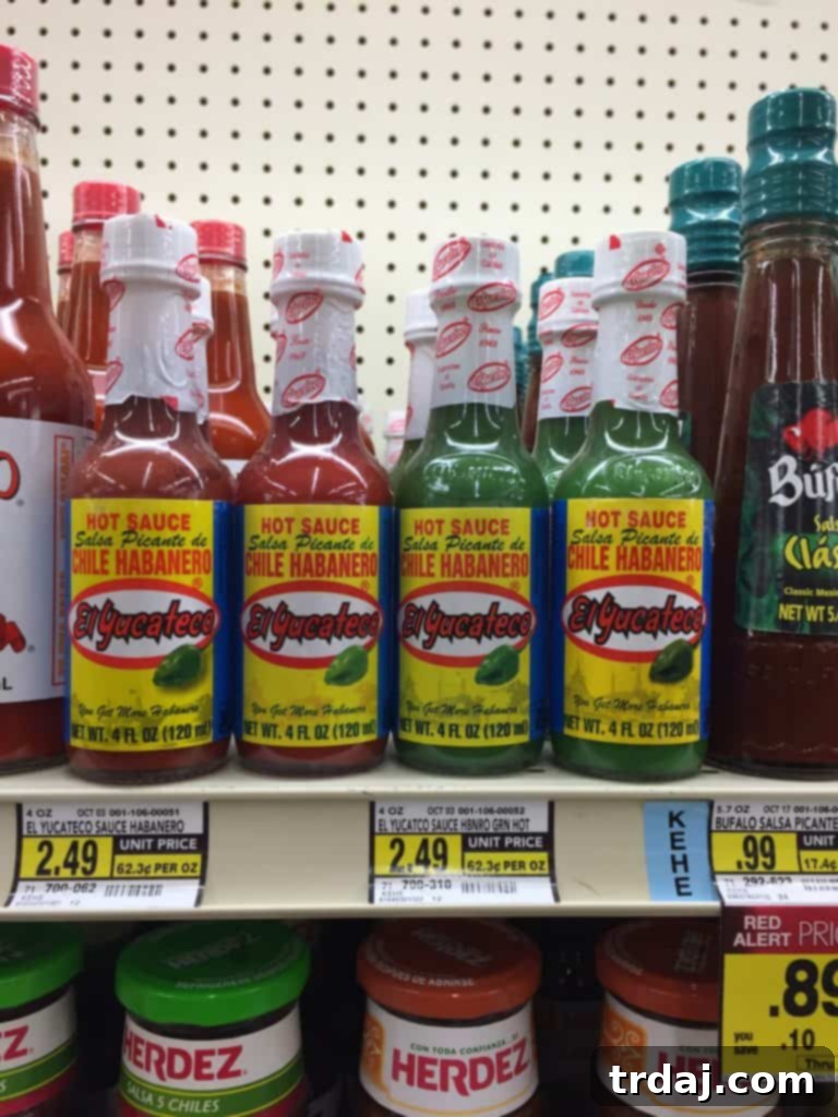 Slow-Cooked Short Rib Sandwiches 5 Close-up of El Yucateco hot sauce bottles, perfect for adding flavor to Short Rib Sandwiches. | Strawberry Blondie Kitchen