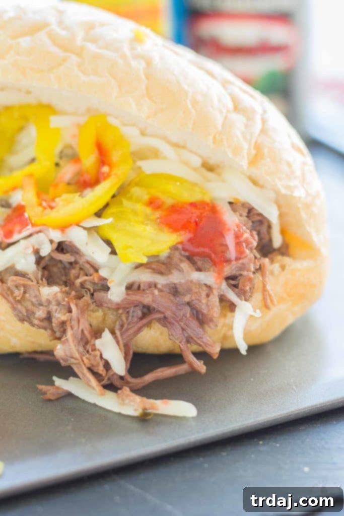 Slow-Cooked Short Rib Sandwiches 9 Close-up of a delicious Short Rib Sandwich, filled with slow cooked beef and El Yucateco hot sauce. | Strawberry Blondie Kitchen