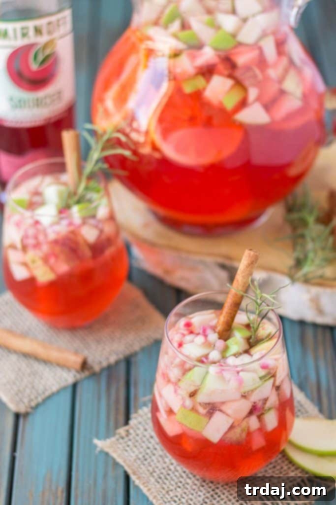 Cranberry Apple Rosemary Sangria: A delicious blend of cranberries, apples, cinnamon, rosemary, and seasonal fruits, perfect as an autumn cocktail from Strawberry Blondie Kitchen.