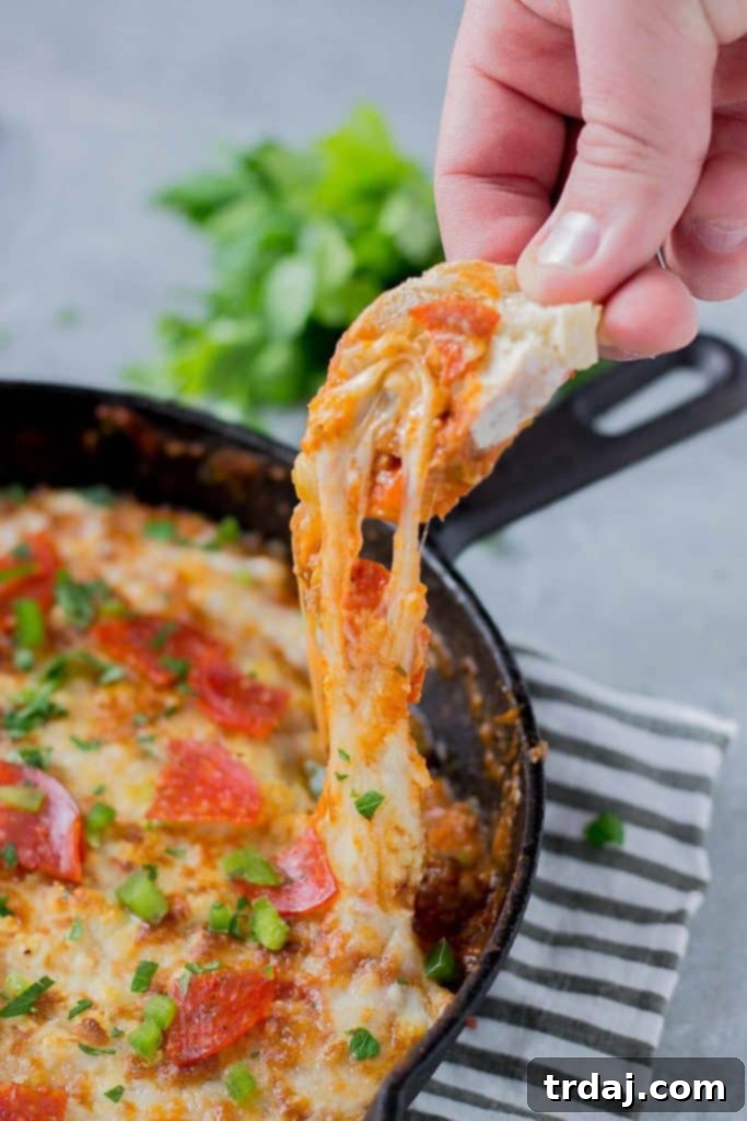 Delicious Supreme Pizza Dip with rich cheese and fresh toppings, ready for serving.