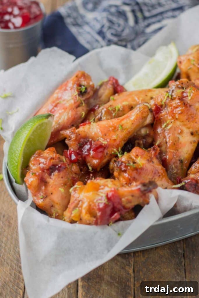 Sweet, tart and tangy, these Cherry Lime Baked Wings are delicious and addictive. Be sure to make a big batch, they're sure to be the hit of your next game day party! | Strawberry Blondie Kitchen