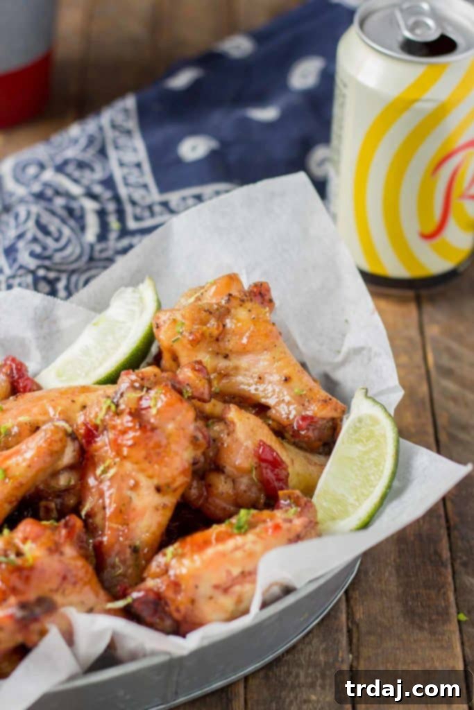 Sweet, tart and tangy, these Cherry Lime Baked Wings are delicious and addictive. Be sure to make a big batch, they're sure to be the hit of your next game day party! | Strawberry Blondie Kitchen