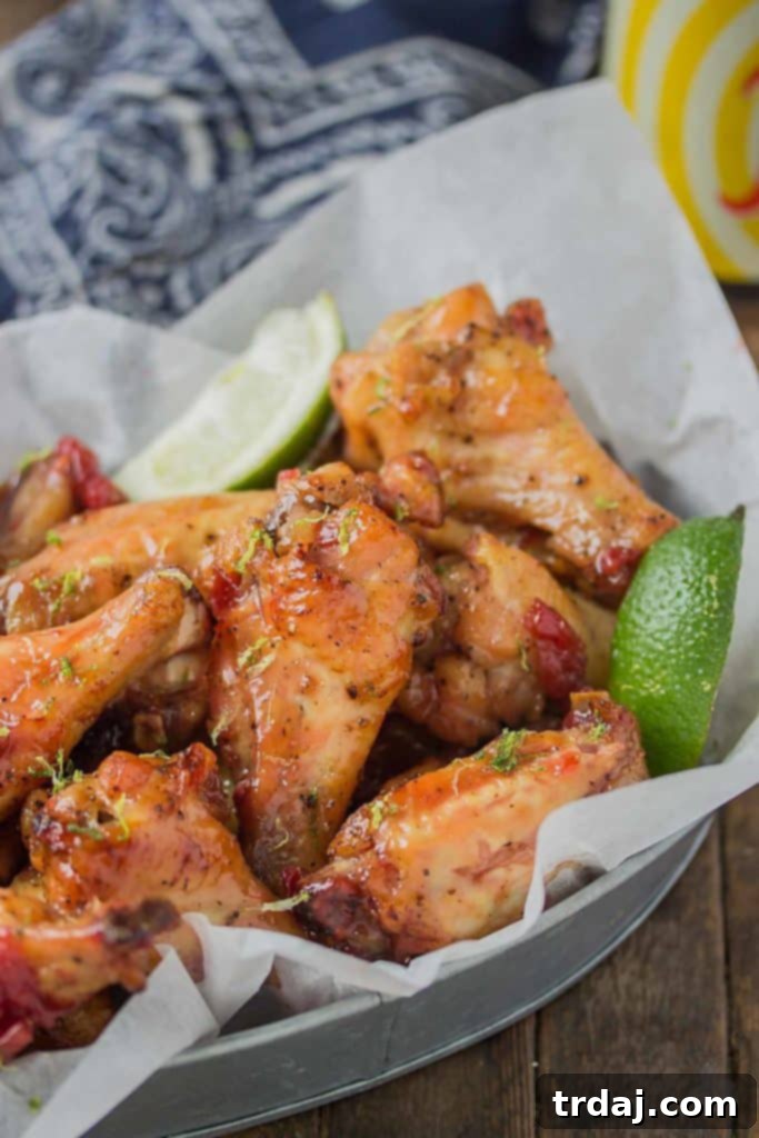 Sweet, tart and tangy, these Cherry Lime Baked Wings are delicious and addictive. Be sure to make a big batch, they're sure to be the hit of your next game day party! | Strawberry Blondie Kitchen