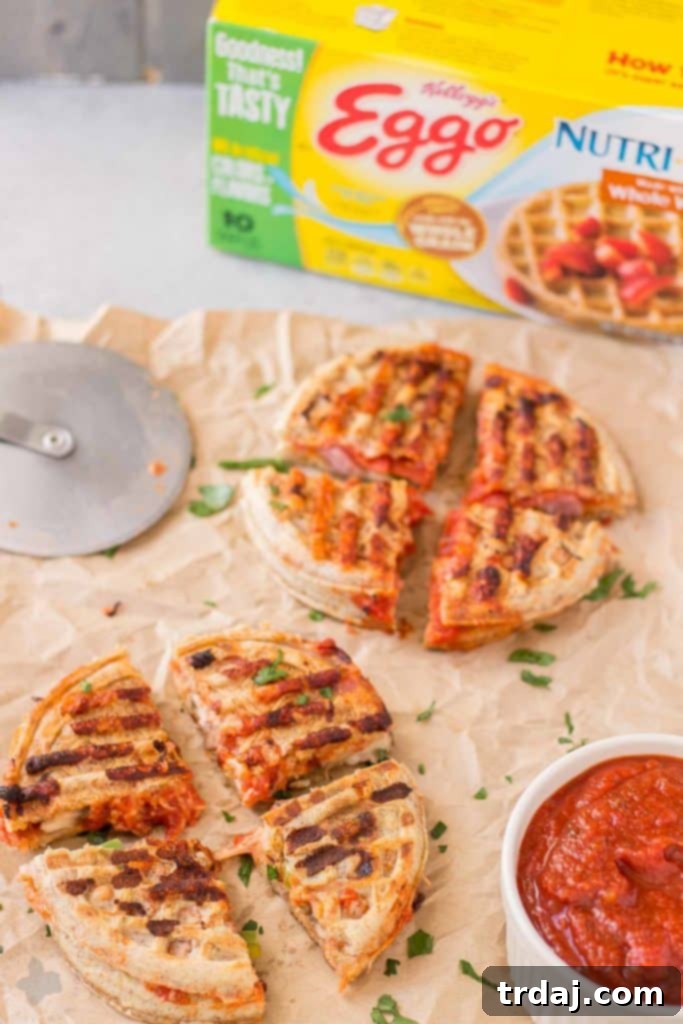 Waffle Pizza Pockets 2 Kids laughing and actively participating in making customizable Pizza Wafflewiches, spreading sauce and adding various toppings like pepperoni and cheese onto toasted Eggo Waffles. | Strawberry Blondie Kitchen