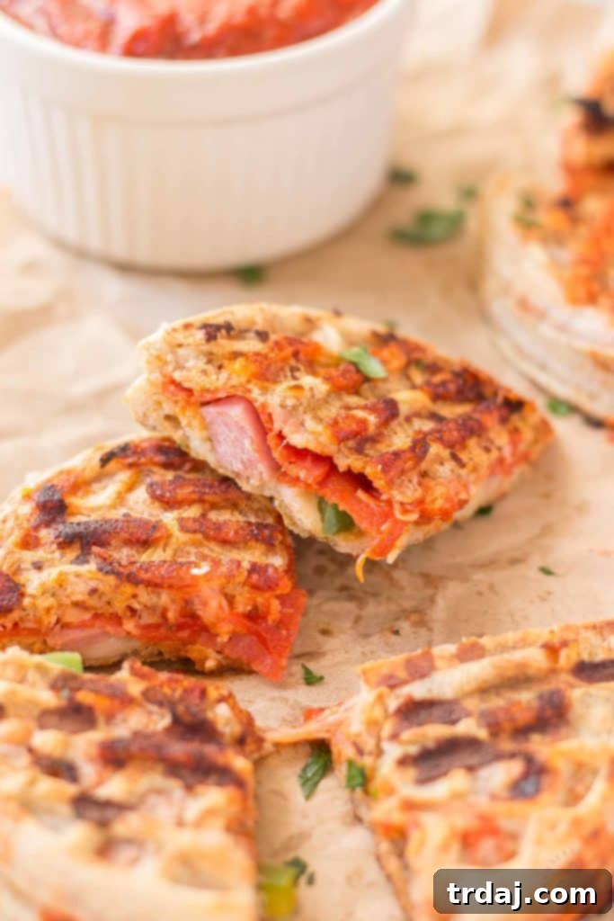 Waffle Pizza Pockets 3 A vibrant close-up shot of a stack of freshly toasted Kellogg's Eggo Waffles, perfectly golden brown and ready to be transformed into creative and delicious Pizza Wafflewiches for a quick and fun family dinner. | Strawberry Blondie Kitchen