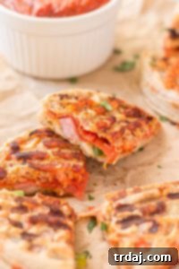 Waffle Pizza Pockets 8 A single perfectly toasted Pizza Wafflewich, cut diagonally to reveal the delicious melted cheese and pepperoni filling, ready for a delightful family meal. | Strawberry Blondie Kitchen