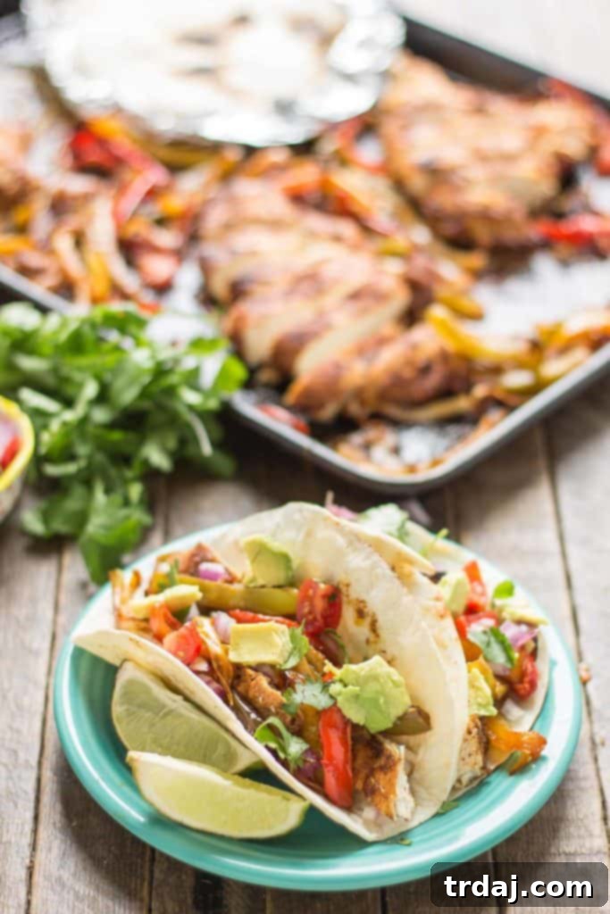 Bursting with flavor and cooked all on ONE pan, these easy Sheet Pan Chicken Fajitas are sure to become permanent in your dinner rotation. You'll love the quick cleanup too! | Strawberry Blondie Kitchen