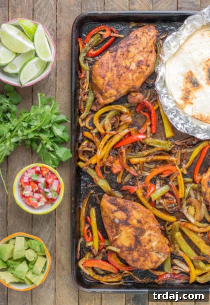 Bursting with flavor and cooked all on ONE pan, these easy Sheet Pan Chicken Fajitas are sure to become permanent in your dinner rotation. You'll love the quick cleanup too! | Strawberry Blondie Kitchen