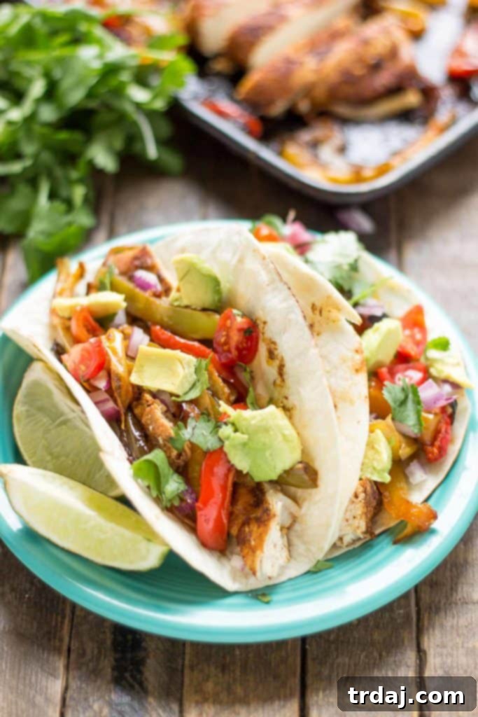 Bursting with flavor and cooked all on ONE pan, these easy Sheet Pan Chicken Fajitas are sure to become permanent in your dinner rotation. You'll love the quick cleanup too! | Strawberry Blondie Kitchen