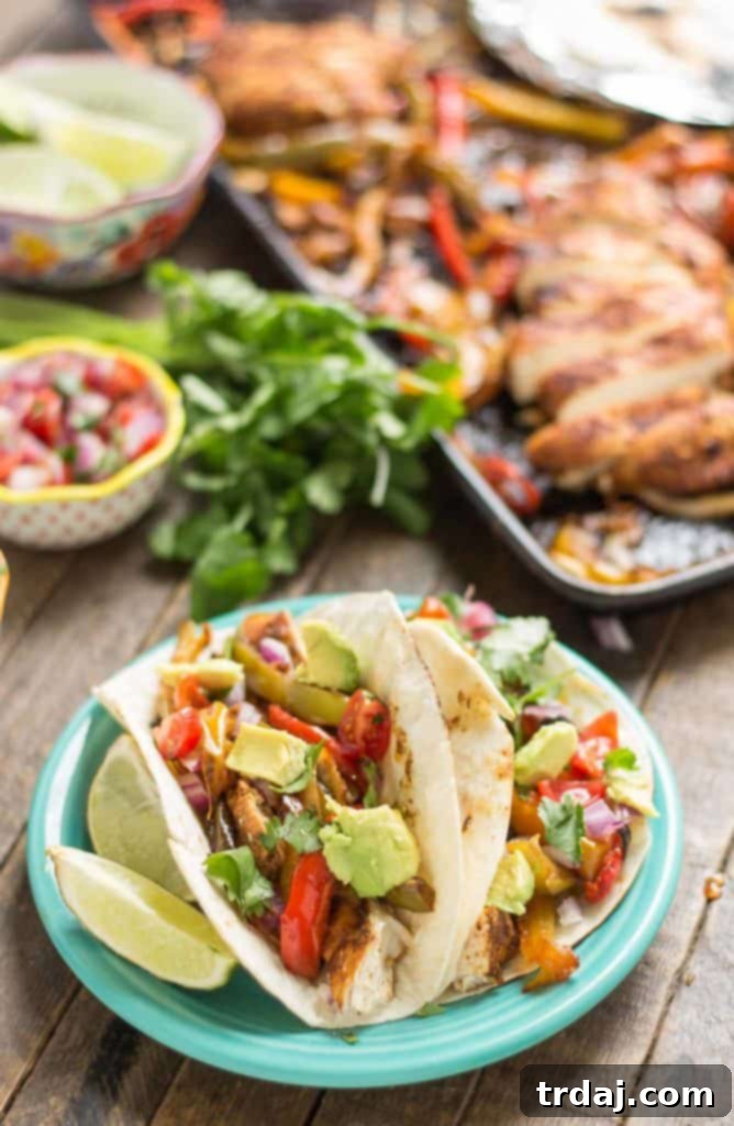 Bursting with flavor and cooked all on ONE pan, these easy Sheet Pan Chicken Fajitas are sure to become permanent in your dinner rotation. You'll love the quick cleanup too! | Strawberry Blondie Kitchen