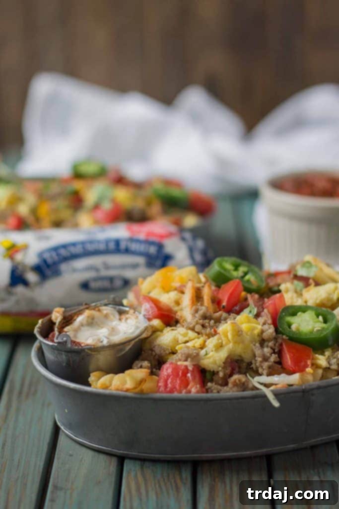 Close-up of a generous serving of The B.E.S.T Breakfast Nachos, highlighting the melted cheese and delicious toppings.