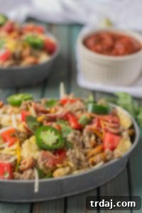 Nachos for breakfast?! Absolutely! Especially when they’re the B.E.S.T Breakfast Nachos; Bacon, Egg, Sausage and Tomato all topped on waffle fries for the ultimate in breakfast satisfaction! | Strawberry Blondie Kitchen