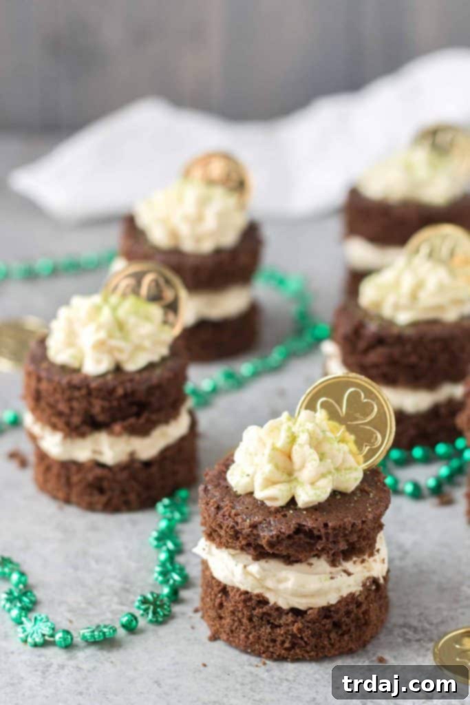 Close-up of a stack of Chocolate Guinness Mini Cakes, showing the moist cake layers and creamy Baileys Buttercream.