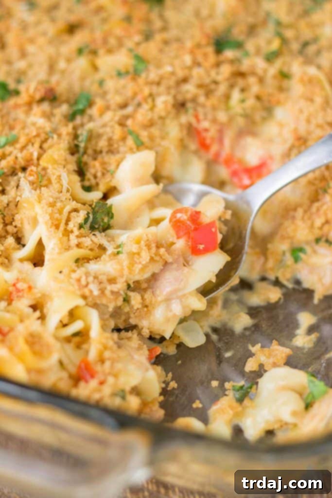 Overhead view of a baking dish filled with Lightened Up Cheesy Tuna Noodle Casserole, ready for the oven.