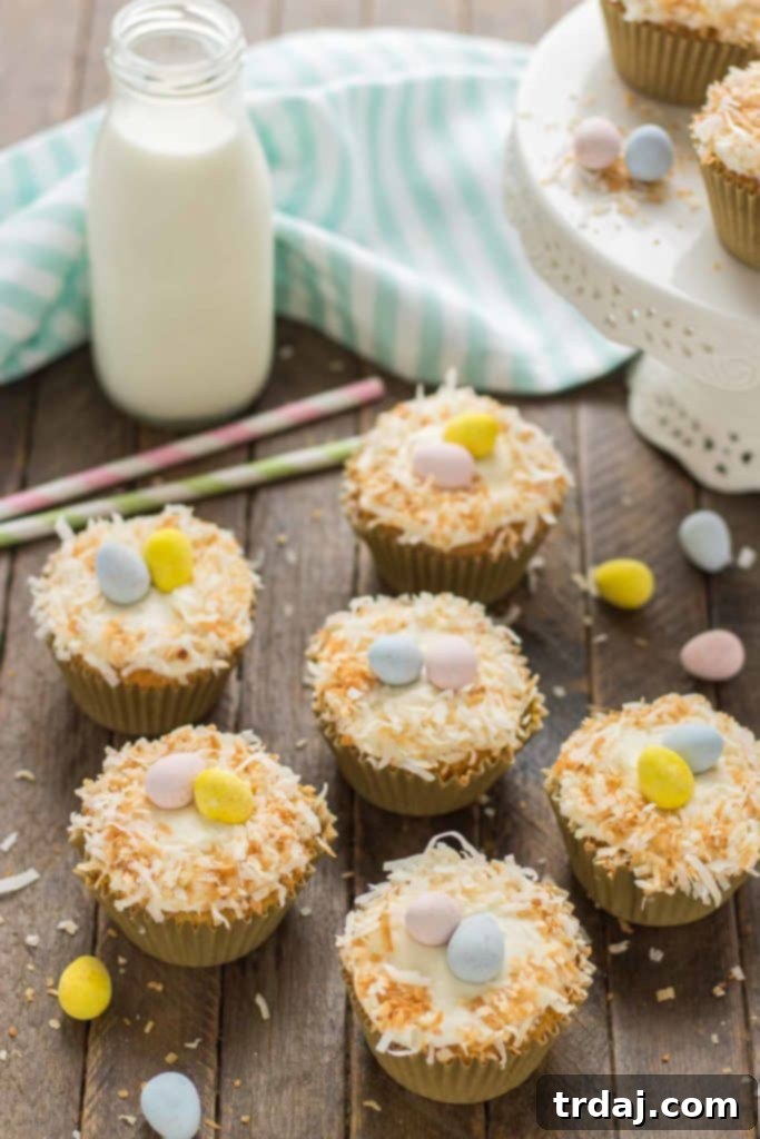 Moist Pineapple Carrot Cake Cupcakes with cream cheese frosting, toasted coconut, and mini eggs, perfect for Spring and Easter