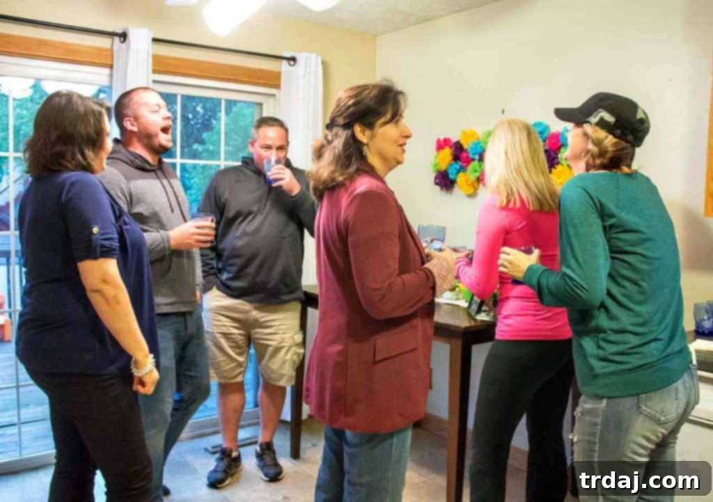 Group of friends toasting with Sauza margaritas at a vibrant outdoor Cinco de Mayo fiesta, surrounded by festive food and decorations.